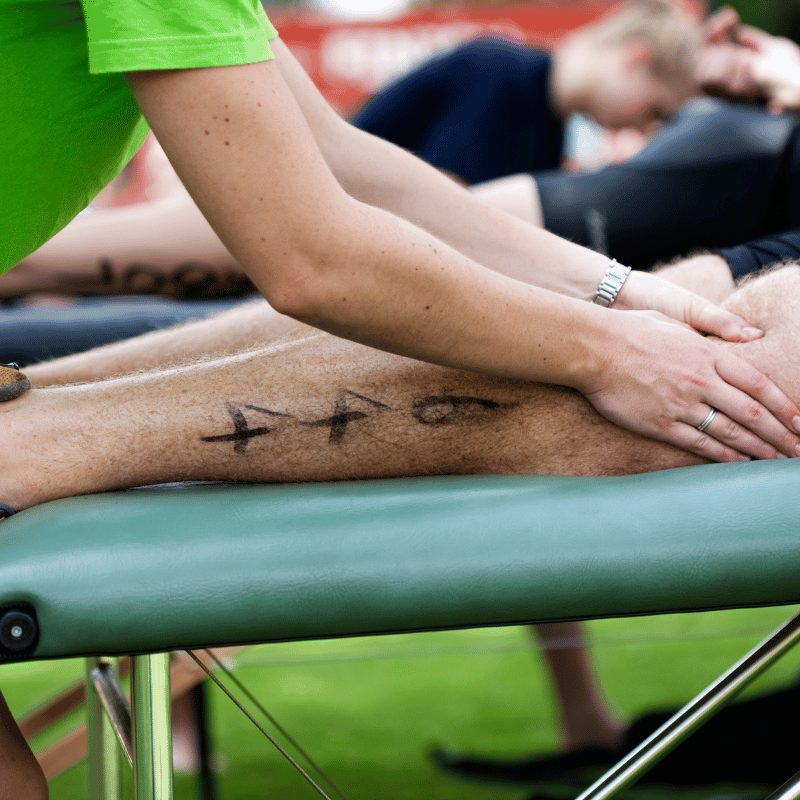 A sports person receiving a leg massage
