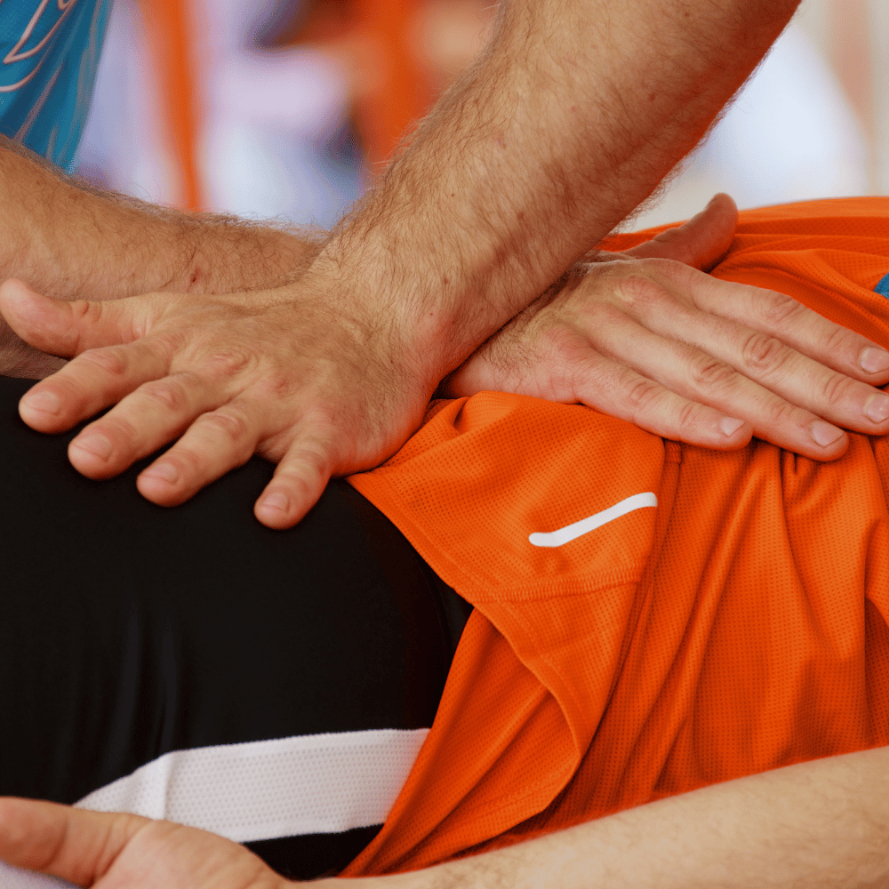 A man giving a sports person a massage